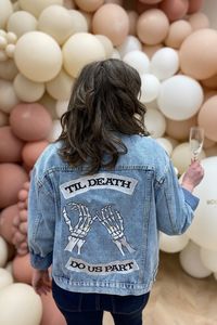 Make a statement on your big day with our edgy Till Death jacket featuring a bold embroidered design. Crafted from high-quality acid washed denim, this jacket is both stylish and comfortable, perfect for a bride who wants to stand out from the crowd. Embrace your inner rebel and add some edge to your wedding day attire with this unique piece.