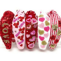 "Celebrate the season of love in style with our hand-beaded custom Valentine's Day knotted headbands! Each headband is meticulously crafted with love, featuring beautiful beads in vibrant colors to add a touch of romance to your outfit. Whether you're dressing up for a date night or simply want to make a statement, these headbands are the perfect accessory to showcase your love for the season. With their unique knotted design, they not only add a pop of color but also offer comfort and versatility. Embrace the love season with our stunning hand-beaded headbands and make a statement that will surely turn heads! Crafted by hand with different motifs, it's sure to be a festive favorite.  Twine and Love exclusive designs  Size: 2.5\" wide Fits: Girls 5Y to Adults 100% Satisfaction Guaranteed.