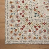 A field of delicate flowers takes on a geometric feel, with rows of small blooms creating a detailed border around a central design. The Laurel collection features elegant area rugs with muted palettes. Power-loomed for extra durability, the Laurel collection is ideal for busy living in any room of the home. | Rifle Paper Co Laurel Eleanor 3'11" x 5'7" Linen Area Rug | Nebraska Furniture Mart