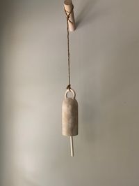 "The perfect ceramic bell for any design look- Modern Farmhouse Eclectic Modern Rustic Organic European Organic Farmhouse Modern Boho Minimal Modern Japandi Wabi Sabi  And every other style in between  A unique decor piece for your home that adds beauty, texture and charm & lovely sound (yes they each have a lovely unique ring) Arrange them hanging from your ceiling, a hook from your wall or a wooden peg like the one shown (all mounting options are sold in my shop)  .  They look amazing in a grouping or simply delightful by itself. Great for indoors or outdoors  Measures: Bell: 10\" long x 2.5\" wide (length includes handle and ringer) The hanging cord  measures approximately  12\" in addition to the above length of bell & ringer ⚠️ Price is for 1 bell 🔔 - made to order 📍 ( pegs/ hooks N