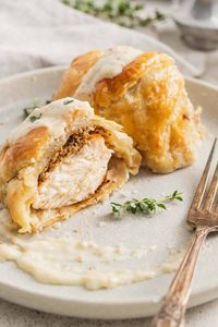 Individual Chicken Wellington make the perfect holiday dinner for less. Budget friendly but still elegant, this chicken in puff pastry is topped with a delightful dijon cream sauce. The perfect date night meal!