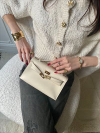 The Kelly Pochette might just be more rare than a Birkin or Kelly bag. They hardly ever come in favorable colors, not to mention a combination of both. Message us for more details, luxury gift ideas, styling advice, and orders from our global Personal Shopping team. Pre-Owned. Condition: Never worn. Limelight Nova is not affiliated with Hermes.