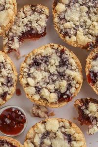 This delicious treat is a cross between a tart and a cookie. A buttery shortbread crust, raspberry jam filling, and sweet and crumbly topping. Enjoy these Raspberry Crumble Cookies alongside a cup of coffee or tea for breakfast, dessert, or a snack.