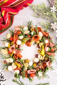 This gorgeous antipasto wreath is an eye-catching festive appetizer to snack on before your holiday meal, and it's so easy to assemble!