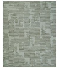 This custom-made, hand-tufted wool rug features a modern design in ivory and olive stripes. Perfect for any room, including kids' rooms, living rooms and bedrooms, this durable rug adds a touch of style and comfort to your space. Made with high-quality materials, it is soft to the touch and adds warmth to your floors.