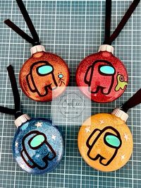 This 4 set of disk shaped, plastic SHATTERPROOF, glitter ornaments encompasses each of the different colored crew mates or imposters with 2 having their "pets" and 2 having star accents. The inside is coated with glitter for no fall out or clean up.  The vinyl used is quality permanent vinyl. Matte black and iridescent vinyl used. Each ornament is 3.5 inches complete with black ribbon for hanging. 