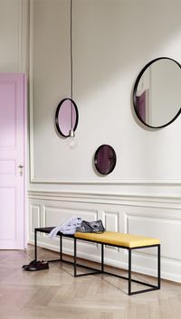 Pops of colour, both from the yellow accents and the pink door, mirrored in our selection of entryway 'Ring' mirrors set the tone for a chic and playful home. #smallspaceinterior #smallspacedesign #smallspacehacks #boconcept #danishdesign #scandinavianliving #design #mirror #roundmirror #trendymirror