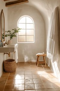 Luxurious spa like bathroom with terracotta tiles mosaic accents and hand painted ceramic sink