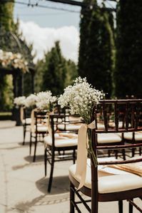 Babies breath chair ties for aisle decor.