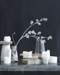 TABLE :: The white flowers and ceramic objects make a beautiful contrast with the dark grey wall...inspiration for a table or dresser top :: Image from Lerkenfeldt Photography | #gray