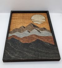 Bring the beauty of nature indoors with our Handcrafted Sunset Wall Art Decor. Meticulously handcrafted with love, this distinctive piece showcases a layered design that captures the breathtaking essence of a mesmerizing sunset. Each layer meticulously added, the vibrant hues and intricate details create a visually stunning piece. This wall art is the perfect addition to any space, adding a touch of serenity and elegance. Perfect for brightening up your living room or giving it as a thoughtful gift!