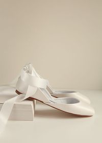 Bridal ballet flats in Pearl Ivory with satin ribbons and leather ankle straps. The tone is in a warmer light ivory with a soft shine. Sustainably made by a women based shoemakers' workshop.  * Standard fit & generally runs true to size * The design is super flattering on all feet shapes and sizes * Leather lining with leather soles (3mm) & anti slip rubber heels (8mm) * Our ballet flats are entirely handmade by us with the highest quality of ethically sourced leather * We ship globally. Estimat