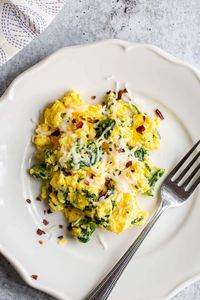 Scrambled eggs with spinach is a healthy and delicious breakfast. These cheesy scrambled eggs are fluffy and the addition of spinach makes the perfect scramble. This recipe uses mozzarella cheese, but it can be easily swapped with parmesan, cheddar, or even feta.