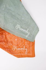 Accessorizing with a western flair has never been easier with this 'Howdy' hand-embroidered bandana in a beautiful orange color. Little Lamb Designs creates handmade embroidered and beaded goods for those who appreciate and understand what goes into creating something truly handmade and unique. Made and based in Avon, Colorado.