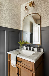 An easy way to elevate a bathroom is by swapping out simple finishes and maybe adding a little bit of wallpaper.