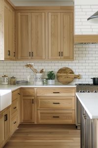 Discover the charm of white oak kitchen cabinets in these 20 beautiful white kitchens. Perfect for creating a warm and inviting space, these cabinets offer a timeless appeal that is hard to resist.