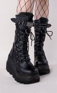 Shake it, baby! These tiered wedges are a cute variation on Demonia's other wedge collections. Vegan Black PU leather 4 1/2 inch wedge Lace up Mid calf length Buckle Rear Zip U.S women's sizing-refer to size chart for more info