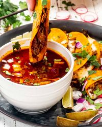 These Birria Tacos have an incredible depth of flavor made with a combination of two meats slowly cooked in an incredible chili-spiced sauce. #beefbirria #tacos #recipe