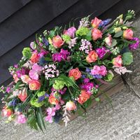 Colourful double ended coffin spray, incorporating peaches, purples, pinks and blues, created by Signature Flowers Bucks and Oxon  #funeralflowers #bespokeflowers #bespokefuneralflowers #bicesterflorist #oxfordshireflorist #sayinggoodbye