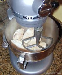 Wish I knew this a LONG time ago. Perfectly shredded chicken in seconds.... throw cooked chicken (still warm/hot) in Kitchen Aid with the paddle attachment. Turn to speed 4-6 and in 20 seconds you'll have perfect, restaurant style shredded chicken.