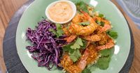 This healthy Shrimp Bang Bang Rice Bowl recipe calls for air fryer shrimp coated in cornflakes and served over cauliflower rice.