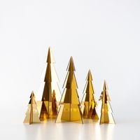 "Transform your space into a winter wonderland with our Set of 5 gold acrylic Christmas trees. These beautifully crafted trees are the epitome of minimalist elegance, adding a touch of holiday magic to your home without overwhelming your decor.  Ideal for tabletops, shelves, mantels, or any small space that needs a festive touch. Arrange them in a cluster, scatter them across different areas, or pair them with your favorite ornaments. Tree sizes range from 10\" to 4\". Each tree comes in two separate halves that effortlessly slot together for a secure and hassle-free setup. These trees stand confidently on their own, creating a charming focal point in any room."