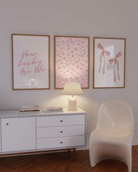 Transform your space with the 'How Lucky Are We' Pink Floral Bow Wall Art Set of 3, perfect for adding a touch of aesthetic charm to your dorm room decor or college apartment. These trendy prints feature lovely light pink floral designs, making them ideal for girly home decor or cute apartment decor. Whether you're embracing grandmillennial art vibes or looking for preppy wall art, this set offers stylish typography prints that resonate with the spirit of inspired art. Elevate your college dorm