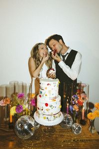 Retro & Colorful Micro-Wedding at the Doyle. Newlyweds feed eachother the wedding cake