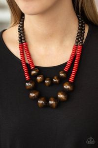 Earthy brown and fiery red wooden beads and discs are threaded along shiny strands of brown cording, creating colorful layers. Features a button loop closure. Includes one pair of matching earrings.