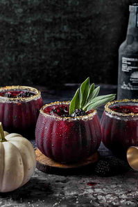 Dark and moody, this halloween cocktail recipe is made with smoky mezcal, blackberries and pomegranate juice.