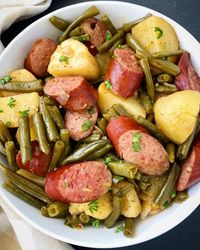 Crockpot sausage, potatoes & green beans is a tasty one-pot recipe that uses simple, affordable ingredients. Also known as Hoosier Stew, this smoked sausage & potato recipe is kid-friendly and family friendly. This is also a recipe that can be served year-round. Instructions to make this easy slow cooker meal in the Instant Pot are also included.