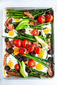 Sheet Pan Breakfast Bake - Gluten and dairy free, one pot meal done in just 30 minutes! Made with eggs, bacon, asparagus, tomatoes and mushrooms. From aberdeenskitchen.com #breakfast #bake #sheetpan #recipe #glutenfree #dairyfree #easy #30minute #egg #bacon #asparagus #mushrooms #tomatoes