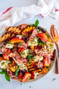 Grilled Nectarine Burrata Prosciutto Salad - The best way to enjoy juicy summertime nectarines, grilled up with cherries, tomatoes, burrata cheese, sliced prosciutto, drizzled with a lemon herb vinaigrette. From aberdeenskitchen.com #grilled #nectarine #tomatoes #cherries #burrata #prosciutto #salad #lemon #herb #vinaigrette #summer #BBQ #recipe