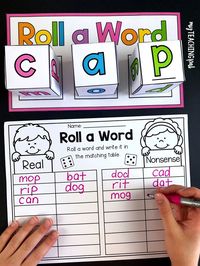 Students roll 3 dice to form a word and then sort it by whether it is real or nonsense.