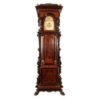 Early 20th century longcase marquetry clock of exceptional proportions, the body of the clock with marquetry panels and flanked by richly carved side panels and raised on hairy paw feet. Possibly Ireland, circa 1900 Measures: Height 12ft - 3 meters Width 3ft - 1 meter Depth 40cm.