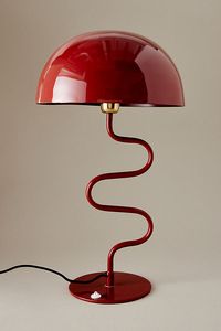 Featuring a contemporary, twisted design, a large enamel shade, and a glossy finish, this lamp adds a modern, artful touch to your table top. | Twist Iron Table Lamp by Anthropologie in Red