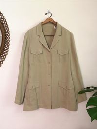 Relaxed and boxy silhouette pistachio green button up aka the perfect transitional lightweight layer for Fall. Made from a medium weight light sage green pure silk this button down features classic double hip and breast square pockets with chic pleat and pointed flap detail. This minimalist wardrobe staple is great as a more casual blazer or boho chic duster jacket. #shacket #shacketoutfitswomen #shacketoutfits #falloutfits2021