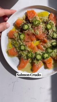 15min · 1 serving     Salmon Crudo & Ginger Scallion Sauce ❤️ it is spicy, coconutty and perfect.  Ingredients:  • 6-8 oz salmon (sushi grade).  • 2 tbsp coconut milk (full fat).  • 1/2 lemon or lime (plus a bit more for drizzling).  • 3 green onions (green and white part).  • 1/4 cup fresh cilantro.  • 1/2 orange.  • 1.5 tsp fresh ginger.  • 1 tsp sesame oil.  • 2 serrano pepper (1 chopped and 1 sliced).  • 1.5 tbsp tamari.  • salt/pepper to taste.  • olive oil to taste.  • flaky salt to taste.  •za’atar to taste.  Directions:  • 1.- mix together the scallion, cilantro, lemon, orange, ginger, tamari, sesame oil, coconut milk, salt, pepper and 1 cilantro. Add to food processor and pulse until chunky smooth.  • 2.- slice the salmon super thin and arrange on a plate.  • 3.- drizzle the scall