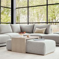 Modern lines meet plush comfort in this beautifully handcrafted coffee table ottoman. With a movable oak overlay and subtle detailing throughout, The Bowery is a study in elegant yet functional living room design. Fully customizable. Available in 45 fabrics & leathers, 2 wood finishes, and 2 sizes.  47-52" Wide, 30" Deep, 16" Tall