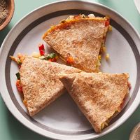 This easy quesadilla recipe uses canned cooked chicken to save time. You can also use leftover cooked chicken or turkey if you have it. Dice the vegetables up to 1 day ahead for even speedier prep.