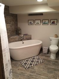 Basement bathroom freestanding tub gray wood porcelain tile