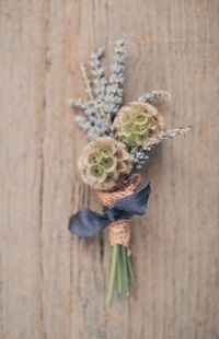 Scabiosa pod boutonniere We love the scabisoa pods for the groomsmen but we were told they break easily and are going out of season - we would love these paired with wax flowers or something that is similar to this