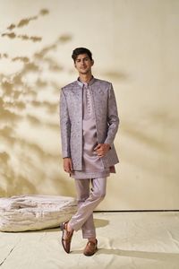 Step into the spotlight with our Lilac Groom Outfit ensemble, perfect for men looking to make a statement at engagements, receptions, or weddings. This striking outfit combines traditional Indian craftsmanship with contemporary style, featuring exquisite detailing and a modern silhouette. Crafted with care and precision, this ensemble exudes elegance and sophistication, making it the ideal choice for the discerning groom. Elevate your wedding attire with this stunning indowestern sherwani and le