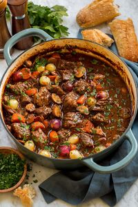 This ultra cozy Beef Bourguignon is a signature French stew made up chunks of rich beef slowly braised in a deeply flavored red wine based sauce, and it's paired with aromatic vegetables and inviting fresh herbs.