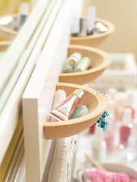 Wall pockets made by cutting wooden bowls in half and mounting them on a painted board