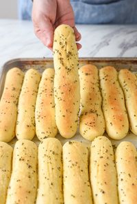 These Copycat Olive Garden Bread Sticks are soft and fluffy on the inside just like the real deal. You can enjoy them whenever you want when you make them at home.