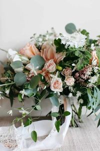 Beautiful lush summer bridal bouquet of dahlias, garden roses, garden spray roses, scabiosa, jasmine, and smilax - Designed by Flora Nova Design Seattle