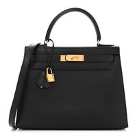 This is the authentic HERMES Box Kelly Sellier 28 in Black. This handbag is crafted of calfskin leather in black. This bag features a rolled leather top handle, optional shoulder strap and polished gold plated hardware. The flap opens with a signature Kelly turn lock to a matching black leather interior with zipper andpatch pockets.