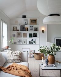 Scandinavian living room decor. Elements of cream and white colours that brighten up the room.