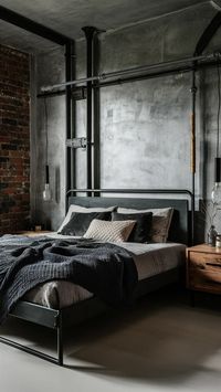 Transform your space with industrial chic! 🛏️✨ This bedroom features an anthracite bed paired with exposed brick walls, metal accents, and rugged wooden furniture. The perfect blend of modern and urban vibes, complete with minimalist lighting. #HomeDecor #IndustrialStyle #BedroomInspo